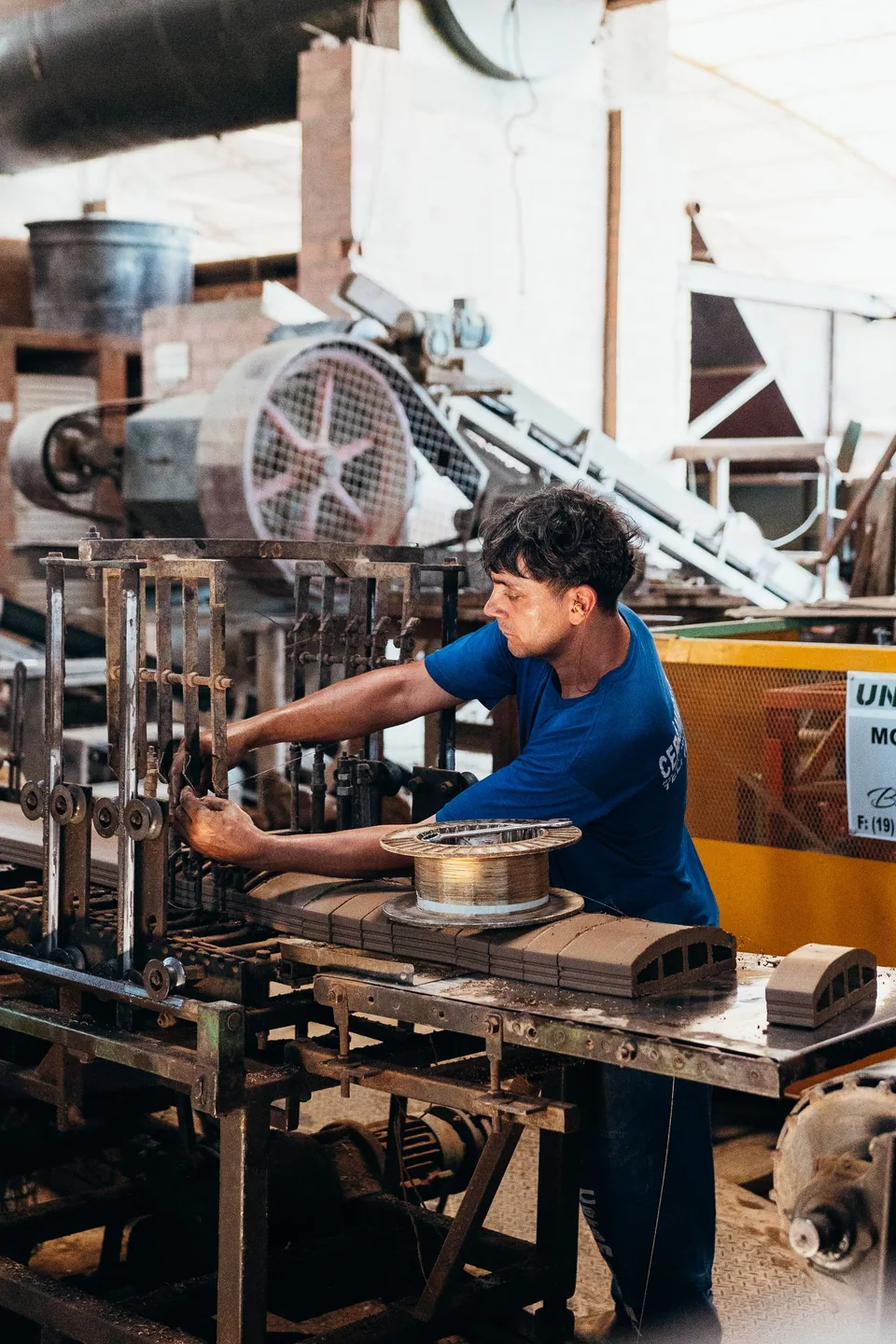 Engineering technician operating factory machinery