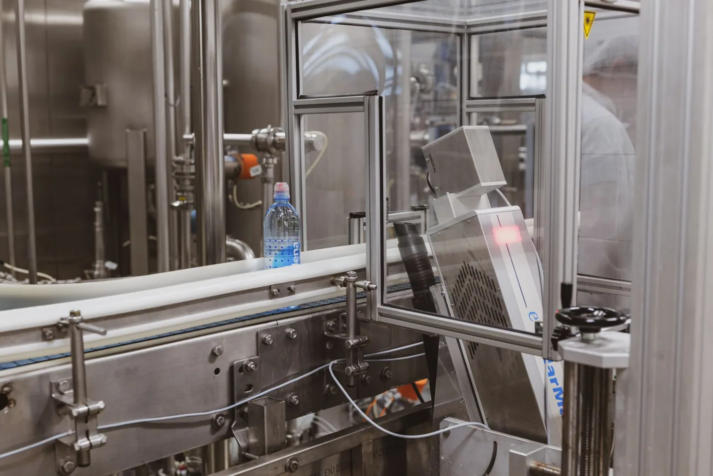 Plastic containers moving along a production line