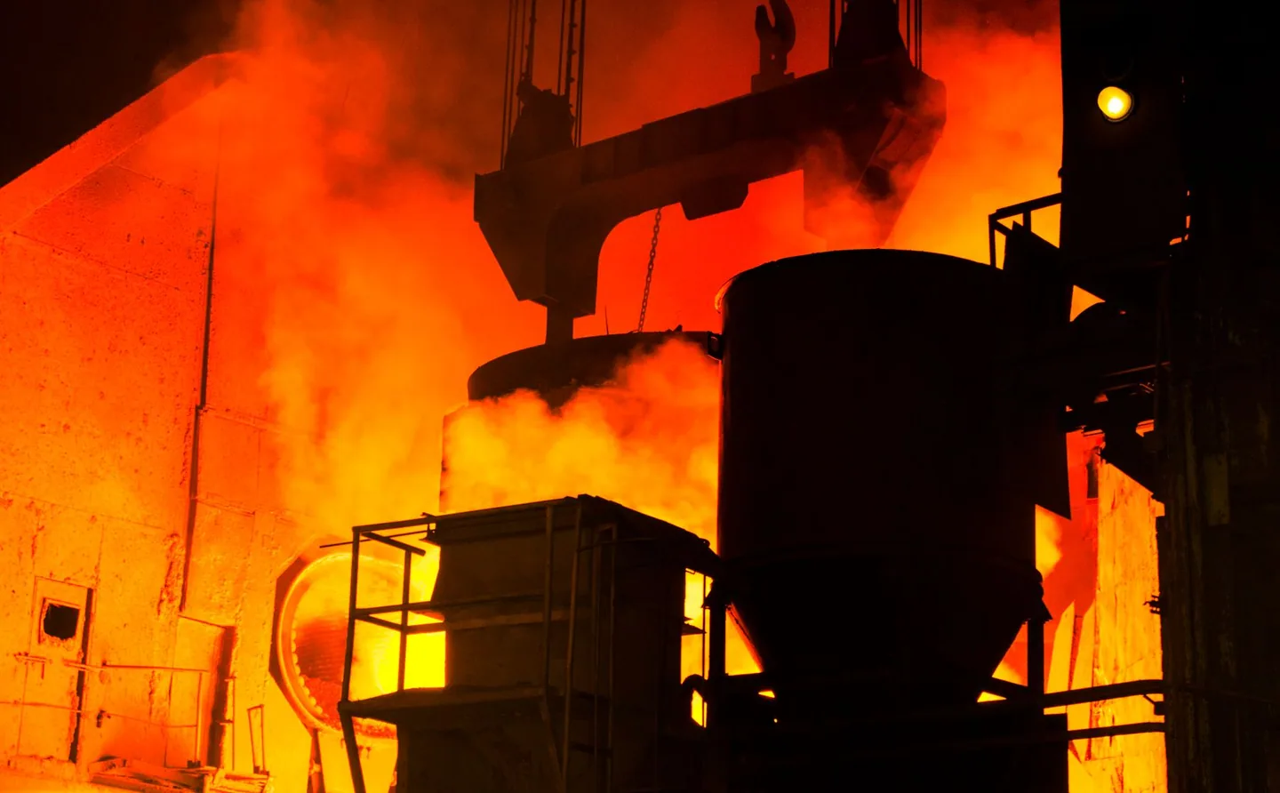 Hot steel moving through an industrial mill