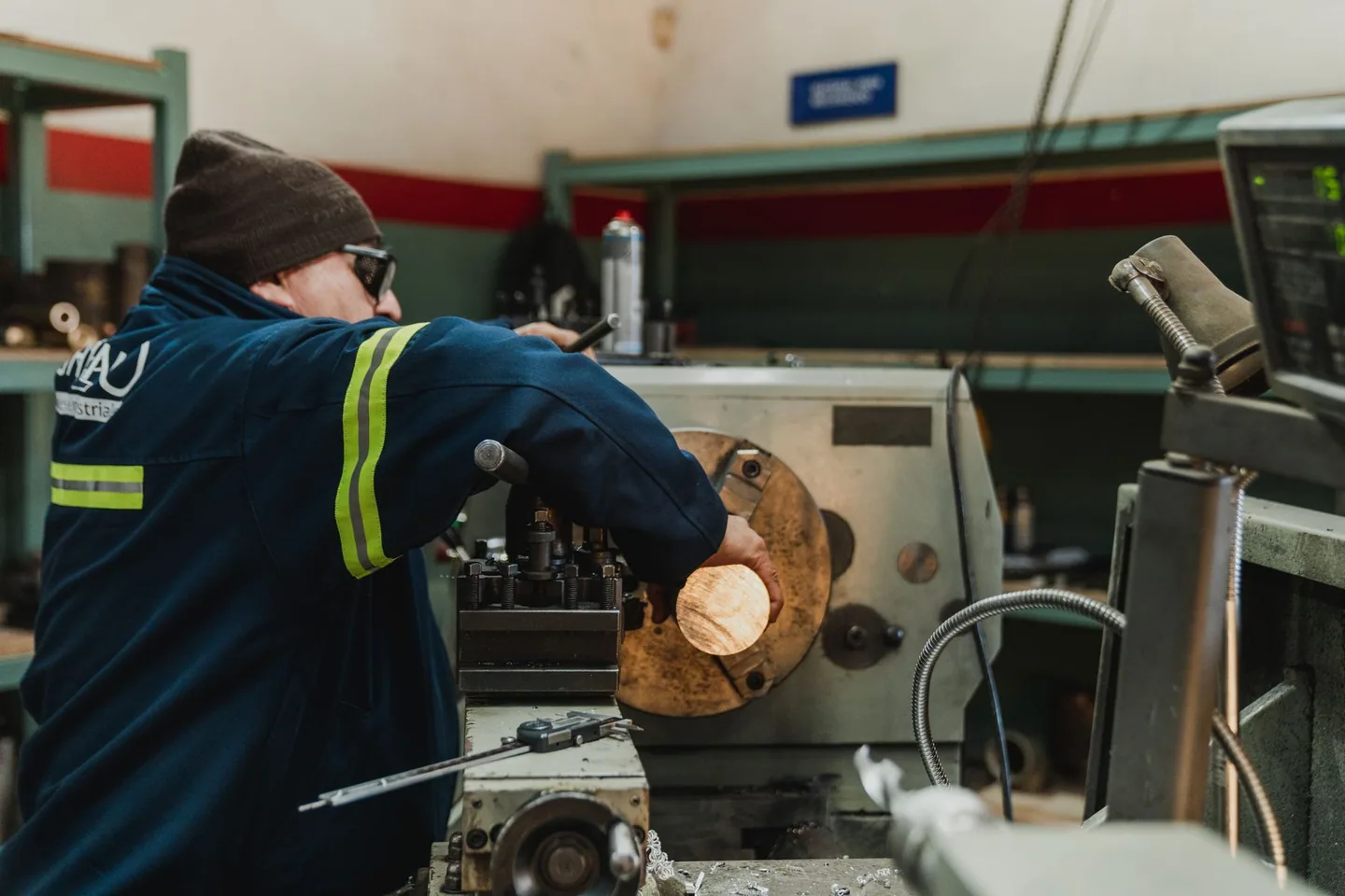 Machinist operating heavy equipment in an industrial workshop