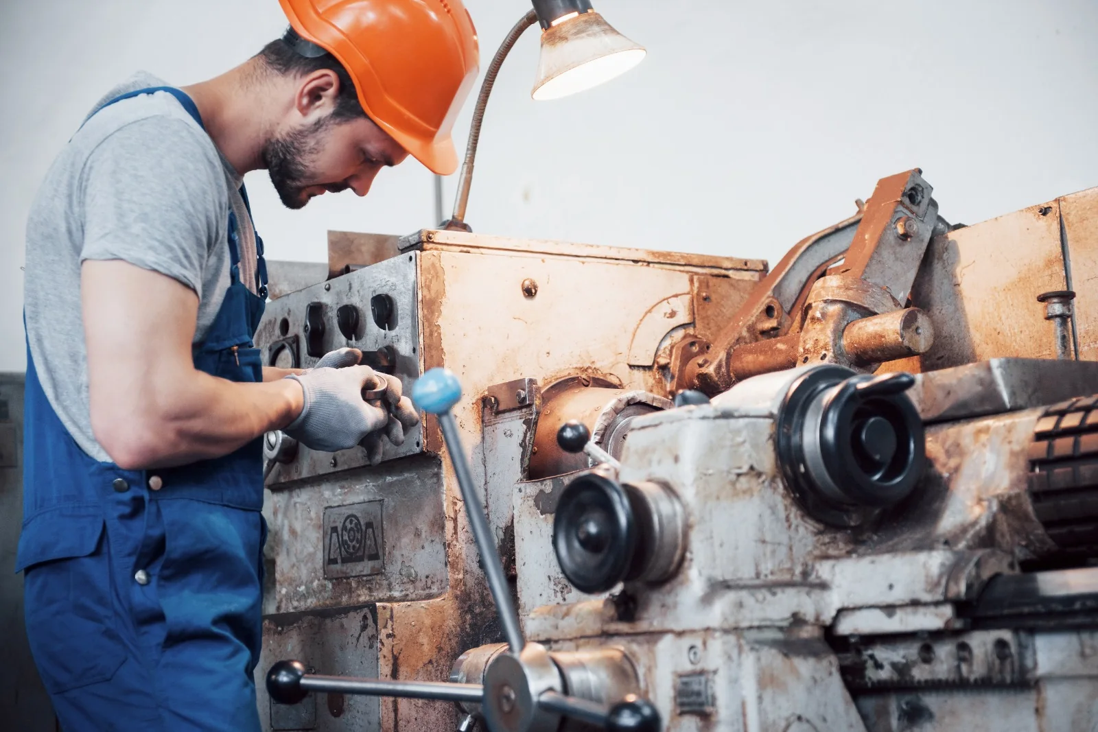 Technician servicing industrial machinery in a workshop